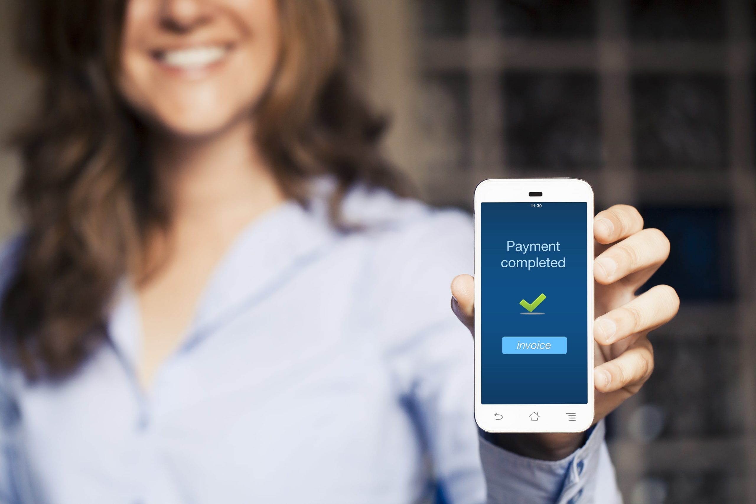 woman-holding-mobile-with-payment-completed